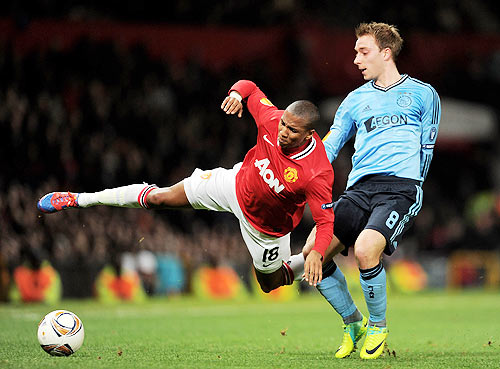 Christian Eriksen of Ajax tangles with Ashley Young of Manchester United