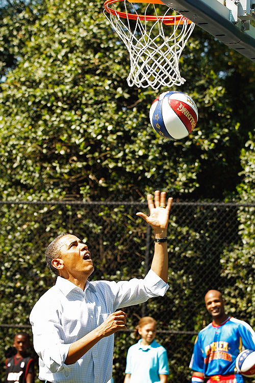 US President Barack Obama shoots a basketball