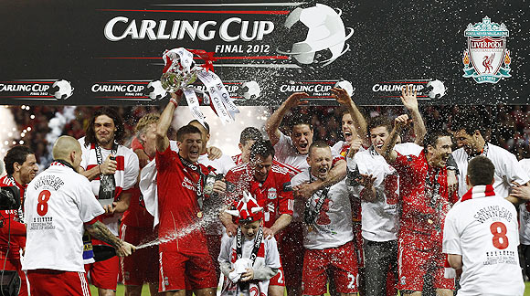 Liverpool's players celebrate after defeating Cardiff City to win the English League Cup final on Sunday