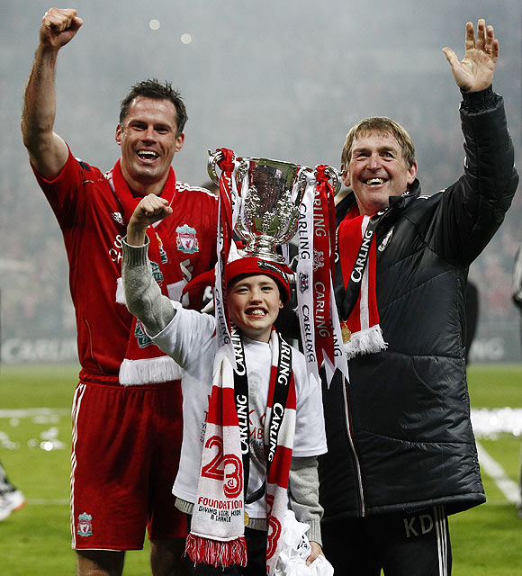 Liverpool's Jamie Carragher (left), his son James and coach Kenny Dalglish (right) celebrate after winning the final