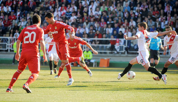 Cristiano Ronaldo (2nd L) of Real Madrid scores his team's opening goal during the La Liga match between Rayo Vallecano and Real Madrid at Estadio Teresa Rivero