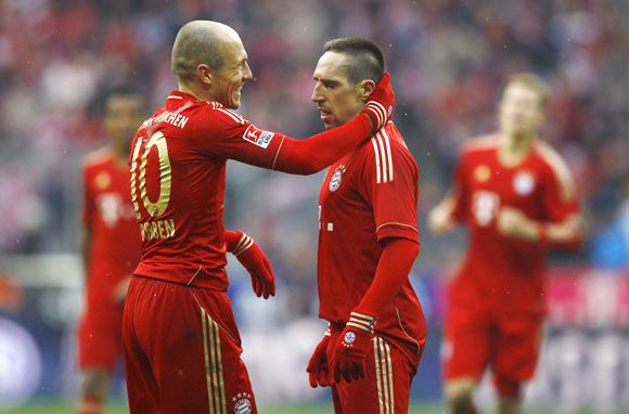Franck Ribery of Bayern Munich celebrates his second goal against FC Schalke 04 with team mate Arjen Robben (L) during their German first division Bundesliga soccer match in Munich