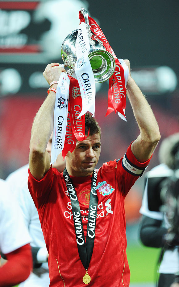 Steven Gerrard of Liverpool celebrates with the trophy after victory in the Carling Cup final on Sunday