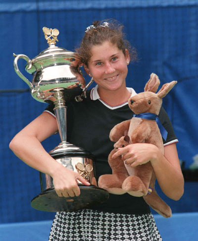 Monica Seles of the USA celebrates with the Australian Open trophy after defeating Anke Huber of Germany to win the final of the Ford Australian Open 1996 at Flinders Park in Melbourne