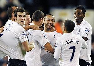 Tottenham Hotspur's players celebrate with Benoit Assou-Ekotto (centre) after he scored the winner against Everton on Wednesday