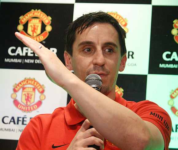 Former Manchester United captain Gary Neville is cheered by the crowd at the Manchester United Cafe in Mumbai on Thursday