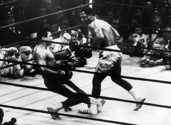 In a fight at Madison Square Gardens in 1971, Ali goes down in the 15th round to a left hook from heavyweight champ Joe Frazier who kept the title.