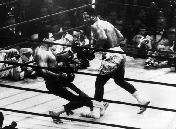 In a fight at Madison Square Gardens in 1971, Ali goes down in the 15th round to a left hook from heavyweight champ Joe Frazier who kept the title.