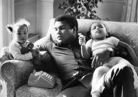 Heavyweight boxer Muhammad Ali with his daughters Laila and Hanna at Grosvenor House in December 1978