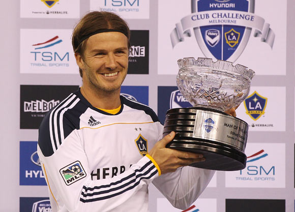 David Beckham of the Galaxy poses with the man of the match trophy during the friendly match between the Melbourne Victory and LA Galaxy at Etihad Stadium