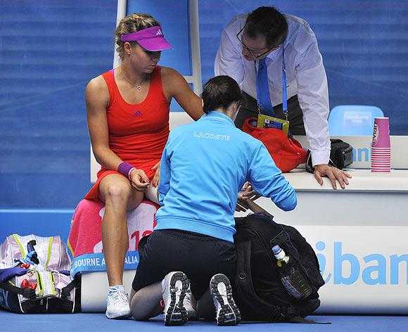 Russia's Maria Kirilenko talks with a match and medical official during her match against Petra Kvitova