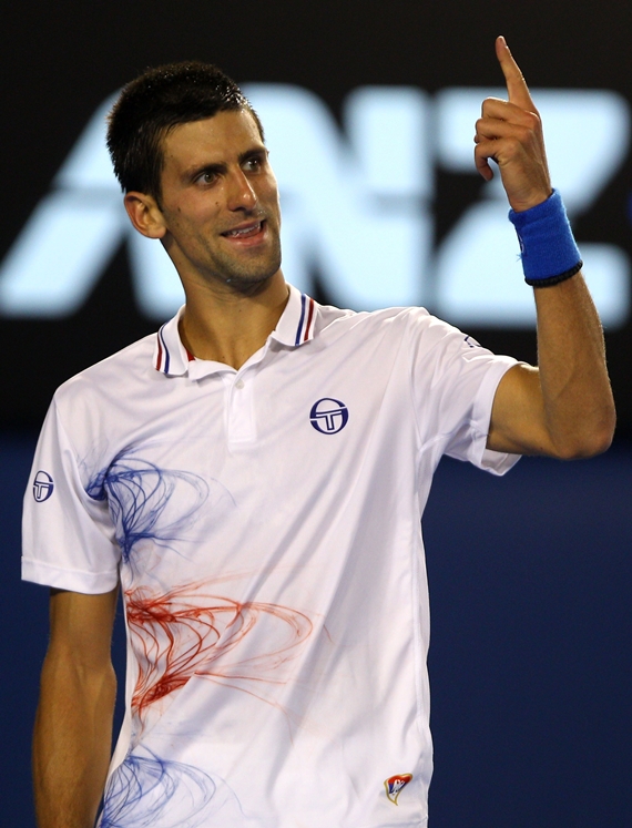 Novak Djokovic of Serbia calls for a challenge in between games in his quarter final match against David Ferrer of Spain