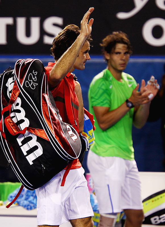 Roger Federer of Switzerland waves to the crowd after losing his semifinal match against Rafael Nadal of Spain