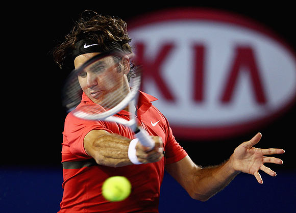 Roger Federer of Switzerland plays a forehand in his semifinal match against Rafael Nadal of Spain