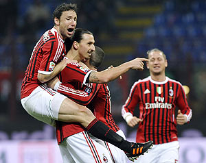 AC Milan's Zlatan Ibrahimovic (centre) celebrates with teammate Mark Van Bommel (left) after scoring against Cagliari during their Serie A match on Sunday