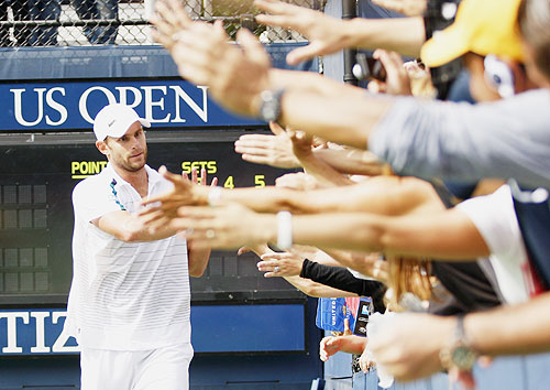 Andy Roddick (left) of the US greets fans