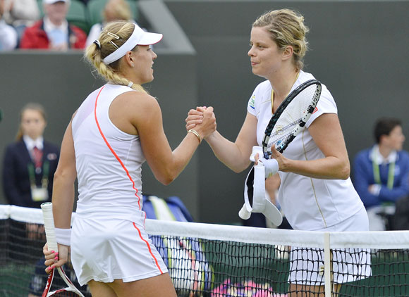 Angelique Kerber of Germany (L) shakes hands with Kim Clijsters of Belgium after defeating her in their women's singles tennis match at the Wimbledon tennis championships in London