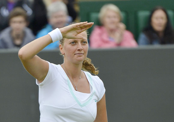 Petra Kvitova of the Czech Republic celebrates after defeating Francesca Schiavone of Italy during their women's singles tennis match at the Wimbledon tennis championships in London