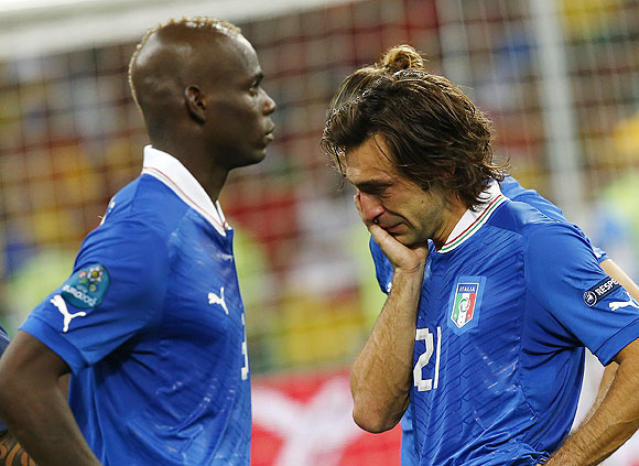 Italy's Andrea Pirlo (right) and Mario Balotelli are crestfallen after losing the Euro final against Spain