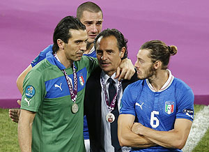 Italy's coach Cesare Prandelli (2nd from right) comforts Gianluigi Buffon, Leonardo Bonucci and Federico Balzaretti after their Euro final loss to Spain