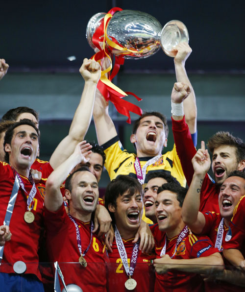 Spain's national soccer players celebrate with trophy after defeating Italy to win Euro 2012 final in Kiev