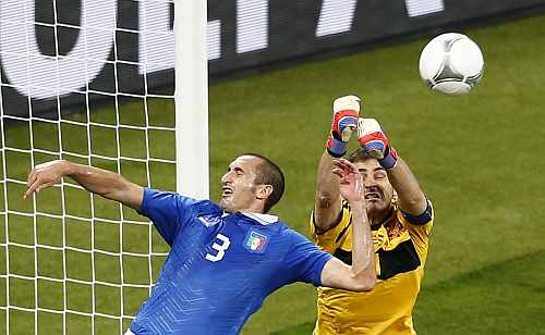 Spain's goalkeeper Iker Casillas (R) makes a save next to Italy's Giorgio Chiellini during their Euro 2012 final match at the Olympic Stadium in Kiev