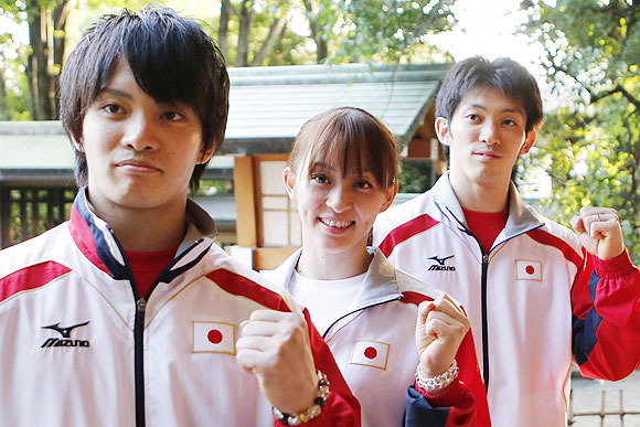 Japanese gymnasts Kazuhito Tanaka, 27, his sister Rie, 25, (centre) and brother Yusuke, 22, (left) pose for photos
