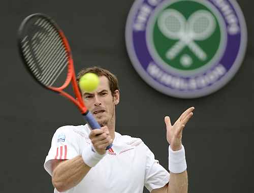 Andy Murray of Britain hits a return to Marin Cilic of Croatia during their men's singles tennis match at the Wimbledon