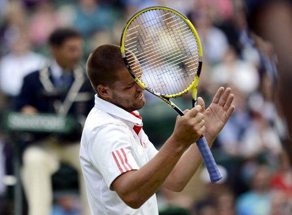 Mikhail Youzhny of Russia reacts during his men's quarter-final tennis match against Roger Federer of Switzerland at the Wimbledon tennis championships in London