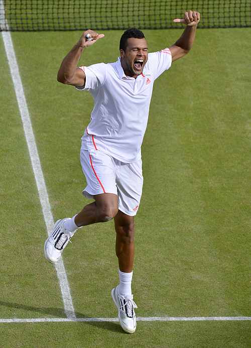 Jo-Wilfried Tsonga celebrates after defeating Philipp Kohlschreiber in their men's quarter-final match at the Wimbledon