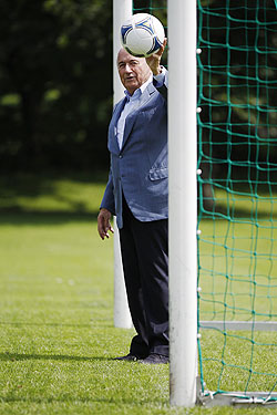 FIFA President Sepp Blatter poses with a ball at the goal line of a goal in Zurich
