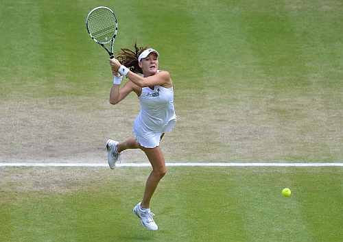 Agnieszka Radwanska hits a return to Angelique Kerber during their women's semi-final match at the Wimbledon
