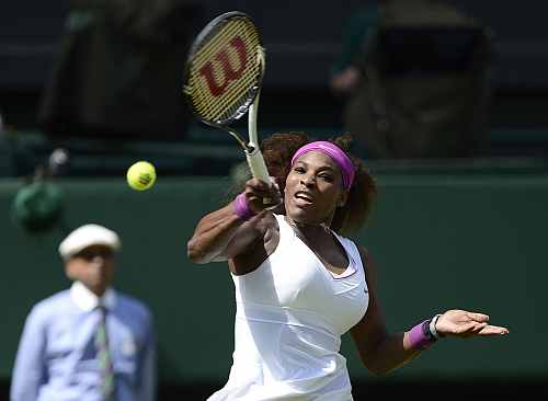 Serena Williams hits a return to Victoria Azarenka during their women's semi-final match at the Wimbledon