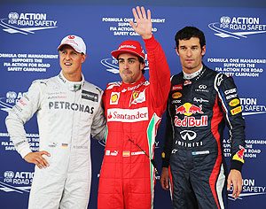 Pole sitter Ferrari's Fernando Alonso (centre) celebrates in with second placed Red Bull's Mark Webber (right) and third placed Mercedes GP's Michael Schumacher following qualifying for the British Grand Prix at Silverstone on Saturday