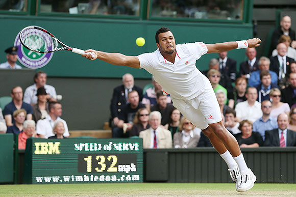 Jo-Wilfried Tsonga of France hits a forehand return against Andy Murray