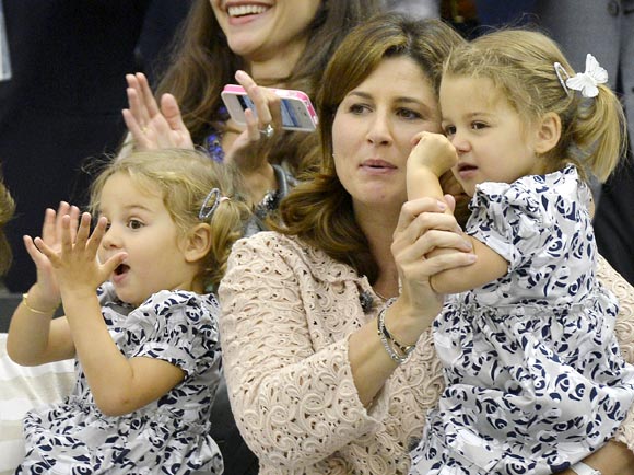 Roger Federer's wife Mirka and their twin daughters Charlene Riva and Myla Rose celebrate his victory in the men's singles final at Wimbledon