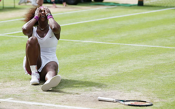 Serena Williams falls to the ground as she celebrates her win against Agnieszka Radwanska on Saturday