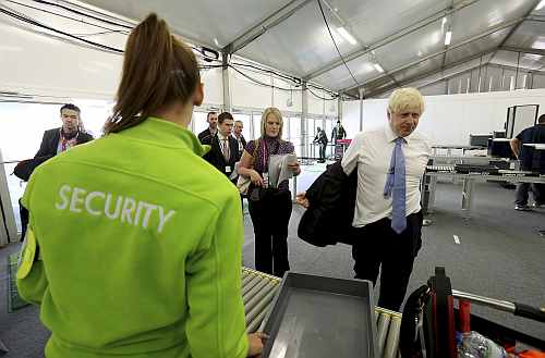 Mayor of London, Boris Johnson, passes through a security check during his visit to the 2012 Olympic Park in London