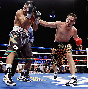 Danny Garcia (right) lands a right hand to the head of Amir Khan