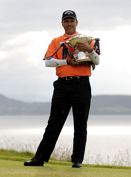 Jeev Milkha Singh of India poses with the trophy after winning the Scottish Open on Sunday
