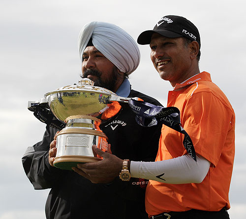 Jeev Milkha Singh and coach Amritinder Singh with the trophy after winning the Scottish Open on Sunday