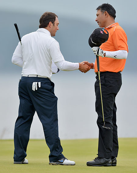 Jeev Milkha Singh (right) greets Francesco Molinari after winning a playoff on the 18th green and with it the Scottish Open on Sunday