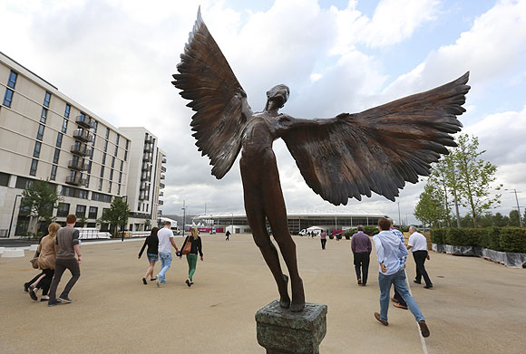 A statue of Icarus marks the way to the 5000 capacity temporary dining hall of the Olympic Village