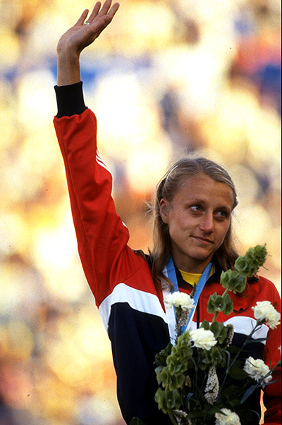Grete Waitz of Norway waves to the crowd after receiving the gold medal for the Marathon event during the World Championships at the Olympic Stadium in Helsinki