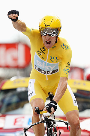 Bradley Wiggins of Great Britain and SKY Procycling punches the air with delight as he celebrates winning the 19th stage and securing the yellow jersey of the general classification of the 2012 Tour de France on Saturday
