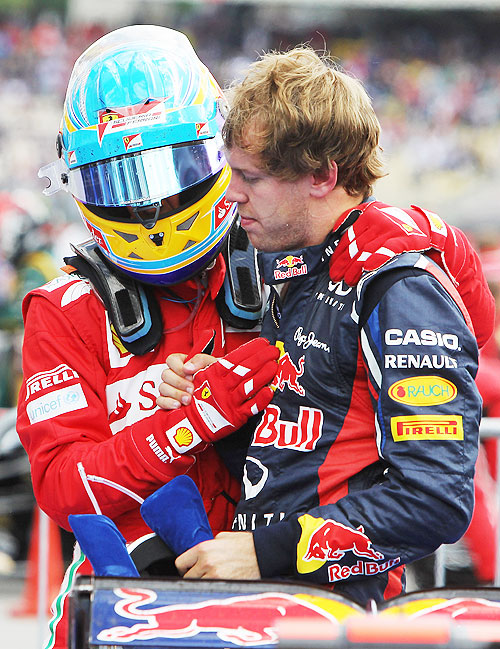 Race winner Fernando Alonso (left) celebrates with second placed Sebastian Vettel