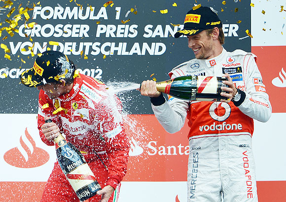 Fernando Alonso (left) with third placed Jenson Button