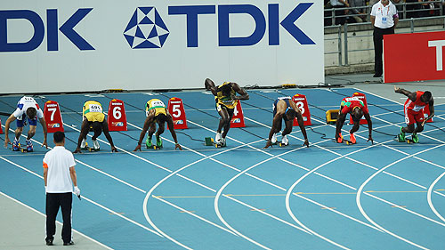 Usain Bolt of Jamaica (4th left) makes a false start