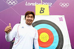 Im Dong Hyun of Korea celebrates breaking the World Record during the Men's Individual Archery Ranking Round on Olympics Opening Day