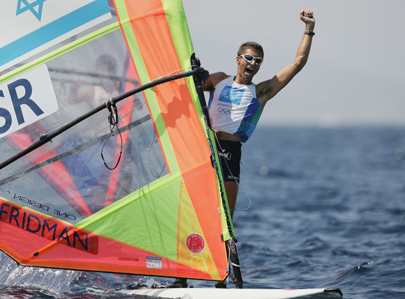 Gal Fridman of Israel celebrates his gold medal  in the men's windsurfer mistral finals race during the Athens 2004 Summer Olympic Games